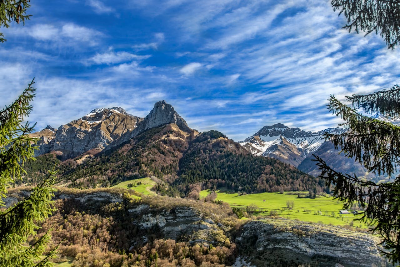 Breathtaking view of lush green valleys and snow-capped mountains in France.